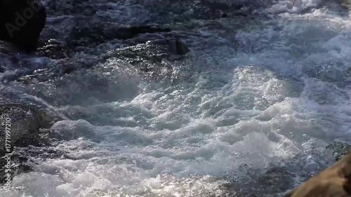The Zelnytsia river rushes through rocky mountain rapids, producing splashes and water sounds. The landscape emphasizes the wild beauty of the mountains.