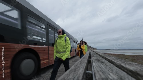 Time lapse video of tidal fields to Mont Saint-Michel, the iconic island abbey in Normandy, France. The stone monastery rises dramatically under a wide, cloud-filled sky.