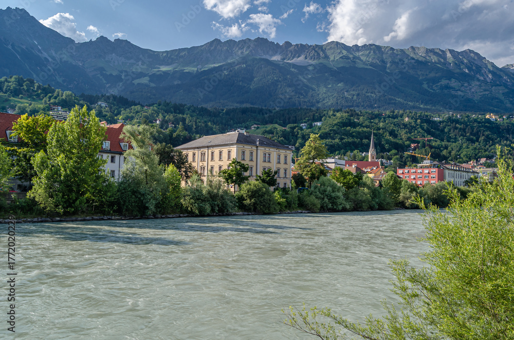 Fototapeta premium Buildings with colorful facades on the banks of the Inn River in Innsbruck, Austria