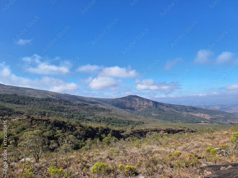 Fototapeta premium Panoramic View of Mountain Highlands Under Bright Blue Sky