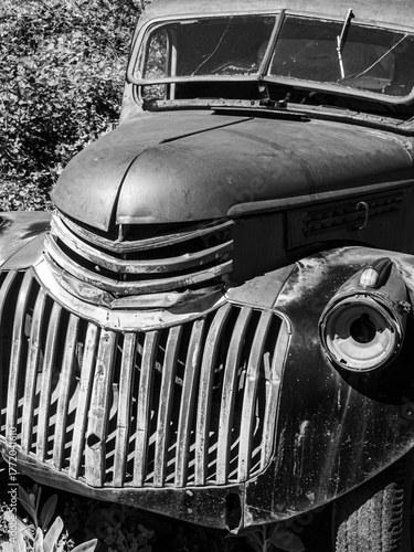 Front of a Rustic broken down car black & white