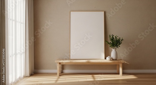 Minimalist living room interior featuring a blank vertical poster frame mockup on a wooden bench, bathed in sunlight from a window with sheer curtains