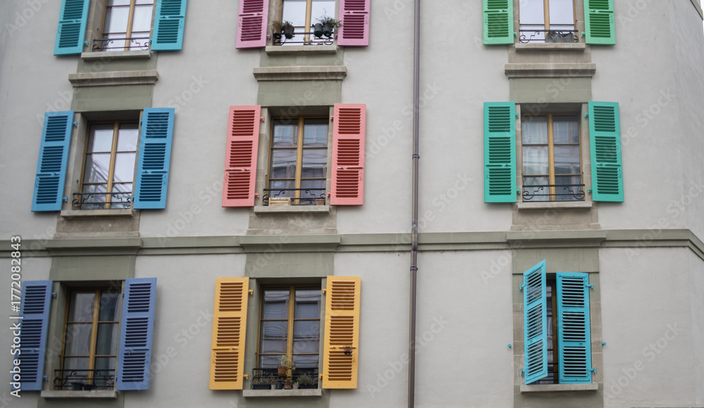 Fototapeta premium Geneva, Switzerland - October 12, 2025: Part of building with colourful shutters.