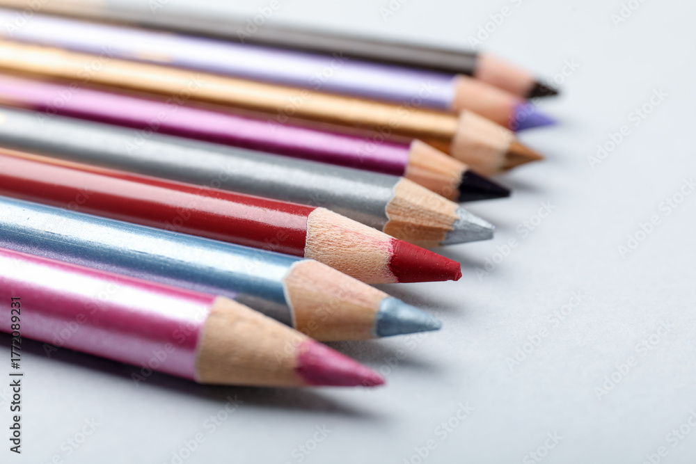 Obraz premium Different eye pencils on light background, closeup