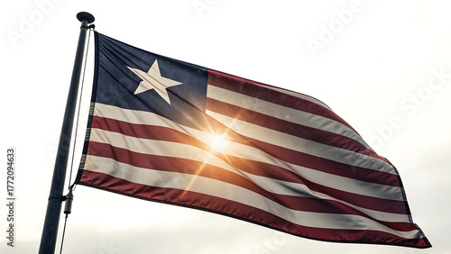 Liberian flag waving in the wind against a bright sky background
