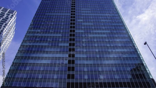 A timelapse of cloud reflecting the urban city building in Tokyo wide shot panning