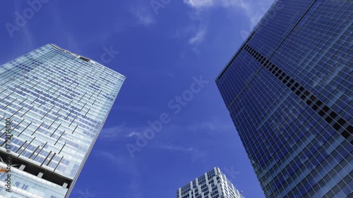 A timelapse of cloud reflecting the urban city building in Tokyo wide shot zoom