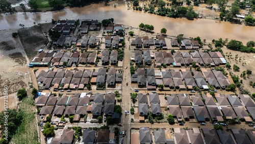 Aerial view of housing estate in suburb of Chiang Rai province flooded by Kok river rising after heavy rain. Chiang Rai hit by flash floods and runoff after overnight rain.