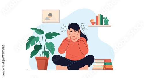 A woman sits on the floor, appearing overwhelmed and distressed, holding her head, possibly due to stress, headache, or noise.