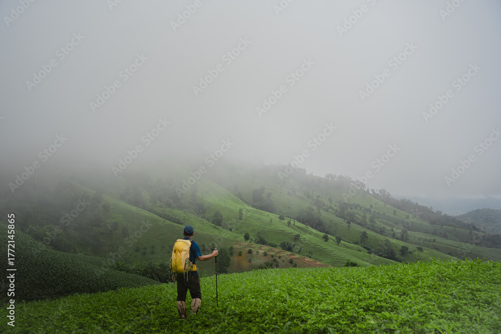 Fototapeta premium Asian man hiking with beautiful view