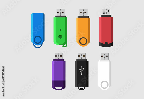 Colorful USB flash drives arranged on a light gray surface for data storage.