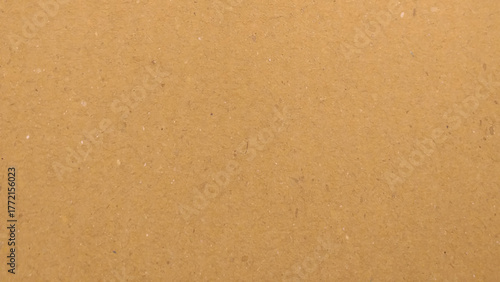 Background of brown kraft paper or cardboard texture. Abstract pattern of beige rough carton, old paper sheet.