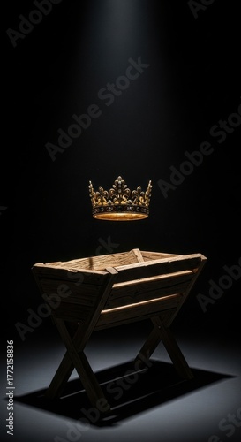 Regal gold crown mysteriously floating above an empty wooden manger in a dark, dramatic spotlight