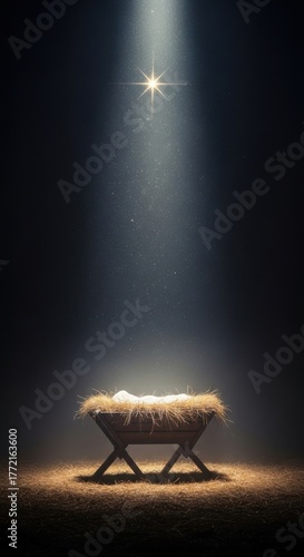 Empty manger with straw and cloth, illuminated by the Star of Bethlehem light beam and sparkle