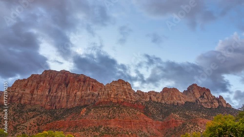 Timelapse of Dramatic red rock mountains under a cloudy sky in the Early Morning
