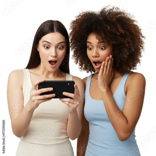 Two young women react with surprise while looking at a smartphone screen isolated