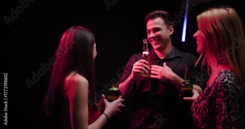 Wallpaper Mural Young Adults Enjoying Drinks and Conversation at a Vibrant Neon-Lit Party, Celebrating Friendship and Togetherness Torontodigital.ca