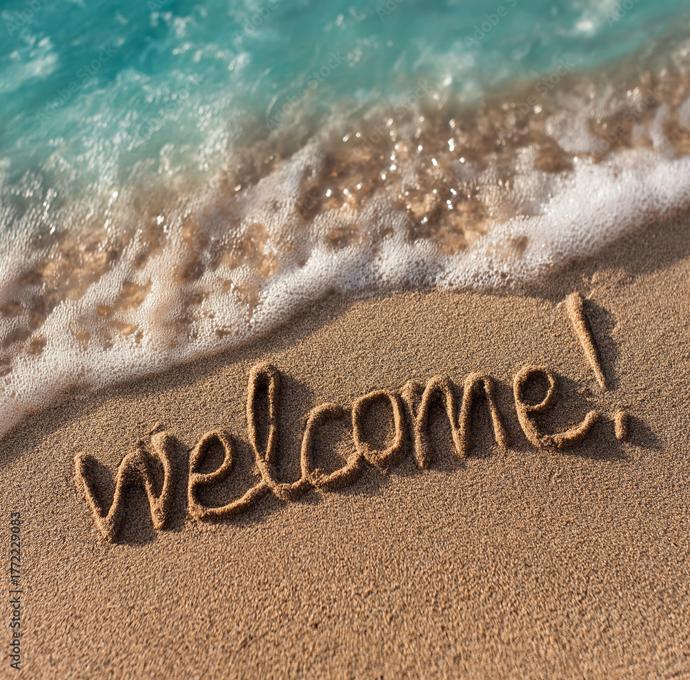 Fototapeta premium the word welcome written in the sand on an exotic beach
