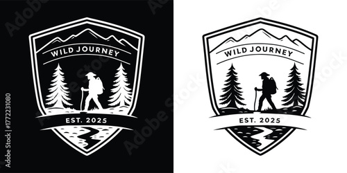 Black and white shieldshaped emblem logo with a hiker silhouette amidst trees and mountains, signifying a wild journey