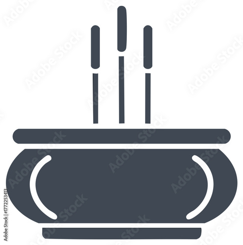 Incense sticks in a bowl. Aromatherapy and ritual object. Spiritual practice and relaxation. Zen tranquility symbol.