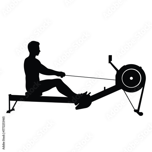 Silhouette of a person rowing on a machine indoors