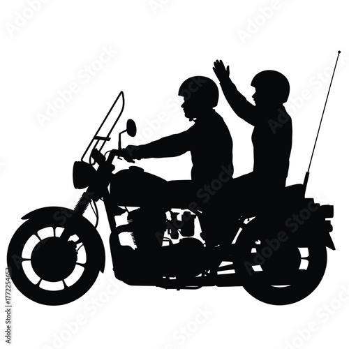Silhouette of two people riding a motorcycle together with one waving