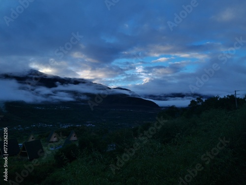 Tibetan plateau village under snowy mountains,Snow-capped mountains, blue sky and Tibetan houses