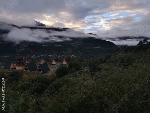 Tibetan plateau village under snowy mountains,Snow-capped mountains, blue sky and Tibetan houses