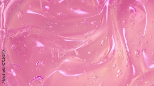 Cosmetics pink serum gel background, transparent cream texture, facial mask 