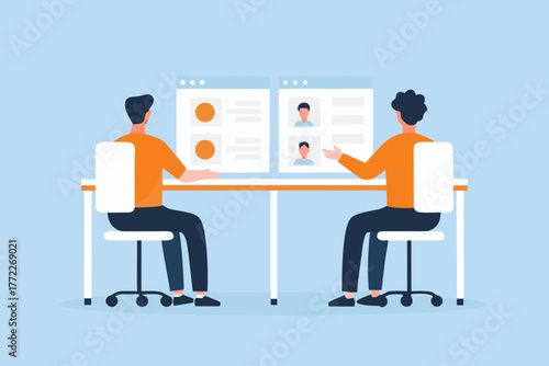 Two people sitting at a desk reviewing candidate profiles on computer screens for hiring decisions