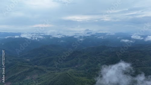 Green mountain valley landscape in Kunming,Mountains and clouds in Kunming, Yunnan,Natural mountain scenery in Kunming,Kunming valley surrounded by green hills,Misty mountain forest in Kunming