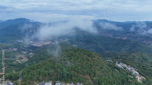 Green mountain valley landscape in Kunming,Mountains and clouds in Kunming, Yunnan,Natural mountain scenery in Kunming,Kunming valley surrounded by green hills,Misty mountain forest in Kunming