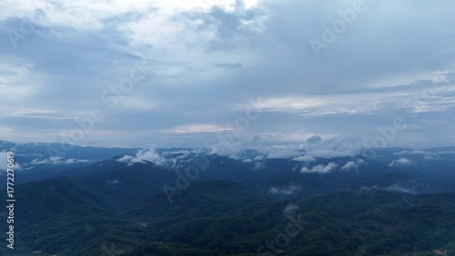 Green mountain valley landscape in Kunming,Mountains and clouds in Kunming, Yunnan,Natural mountain scenery in Kunming,Kunming valley surrounded by green hills,Misty mountain forest in Kunming