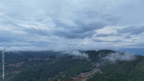 Green mountain valley landscape in Kunming,Mountains and clouds in Kunming, Yunnan,Natural mountain scenery in Kunming,Kunming valley surrounded by green hills,Misty mountain forest in Kunming