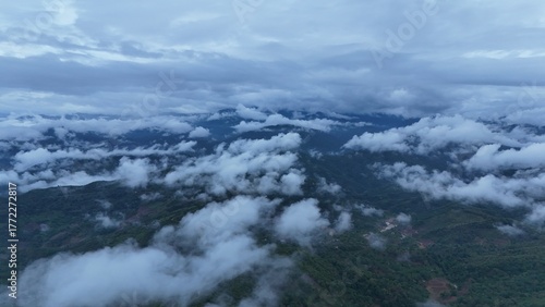Green mountain valley landscape in Kunming,Mountains and clouds in Kunming, Yunnan,Natural mountain scenery in Kunming,Kunming valley surrounded by green hills,Misty mountain forest in Kunming