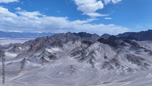 Black Mountain desert mountain landscape,Black Mountain peaks under blue sky,Majestic and desolate scenery of Black Mountain,Black Mountain scenery on the western plateau,Black mountains with blue sky
