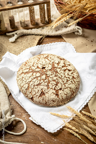 Fresh homemade bread on white napkin with wheat ears and grains