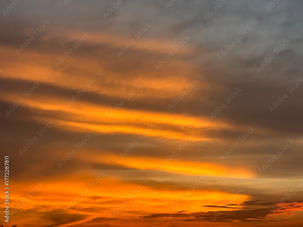 Fototapeta premium Vivid Orange and Grey Clouds at Sunset image photo