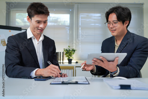 Wallpaper Mural Teamwork makes everything easier. Shot of two young businessmen working together in an office. Torontodigital.ca