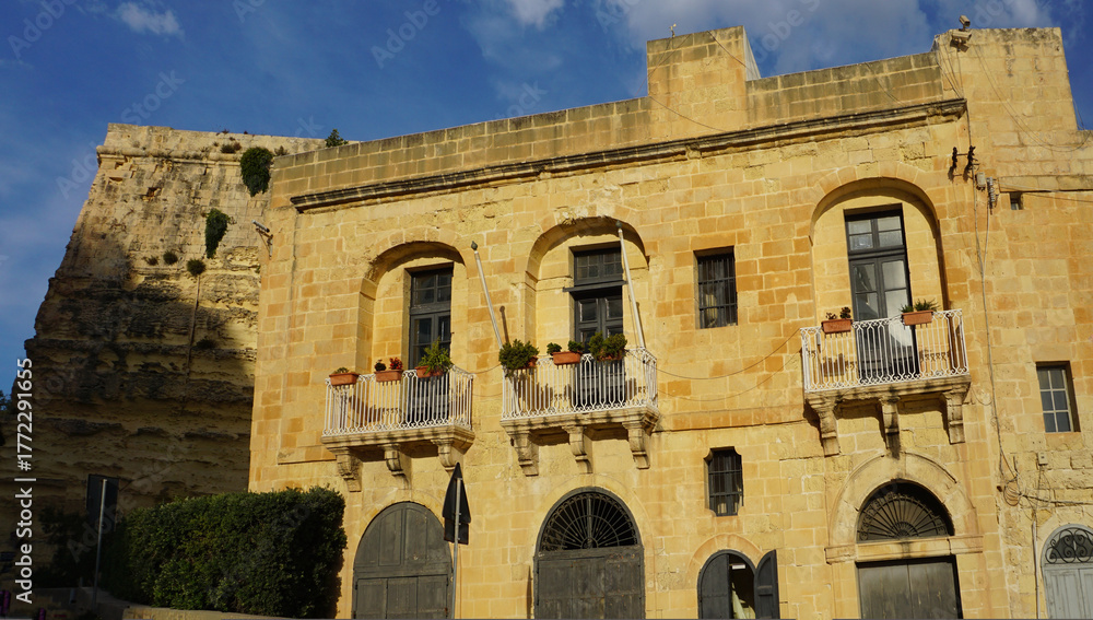 Fototapeta premium View of old building with windows, balconies in city. Republic of Malta, the picturesque city of Valetta, Malta.