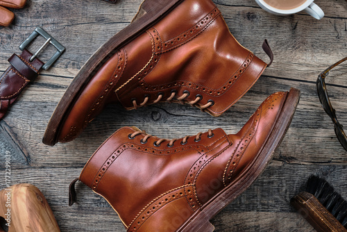 Slika na platnu Wingtip Brogue Boots and Accessories on Wooden Table