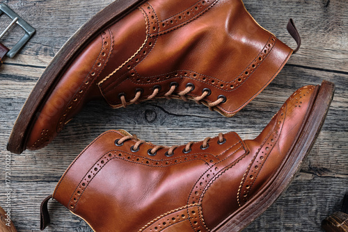 Wingtip Brogue Boots and Accessories on Wooden Table
