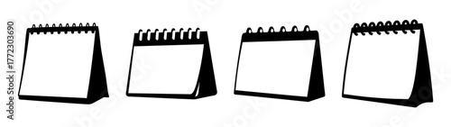 Four blank desk calendars arranged in a row, isolated on a white background