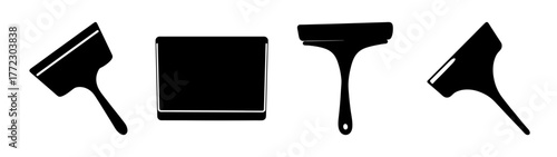 Collection of four black silhouette icons of paint scrapers and spatulas, isolated on a white background