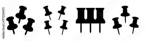 Collection of black push pins scattered on a white background, isolated on white background
