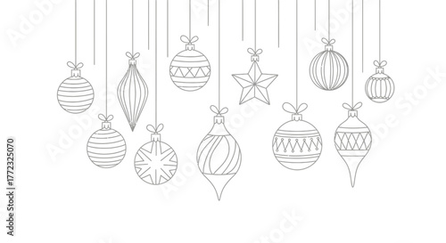 A collection of festive Christmas ornaments hang suspended against a white background.