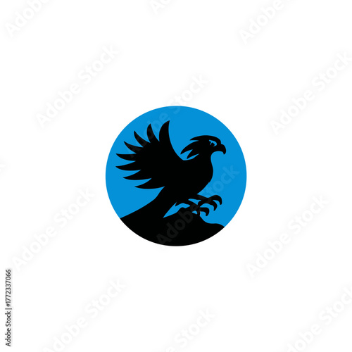 Dynamic black silhouette of an eagle or hawk flying, powerful raptor against a vibrant blue circle background, minimalist graphic design
