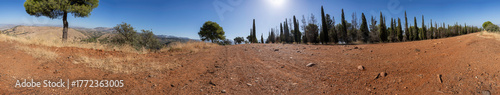 A Beautiful Scenic Panoramic View of a Dry Landscape Featuring Trees Against a Blue Sky