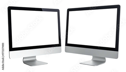 Two silver desktop computers with black screens on a white backdrop