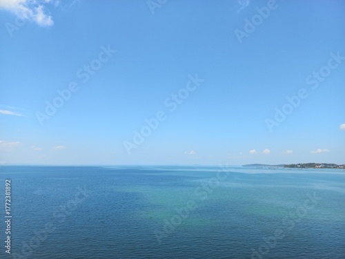 Ocean view with water color gradation and clear blue sky